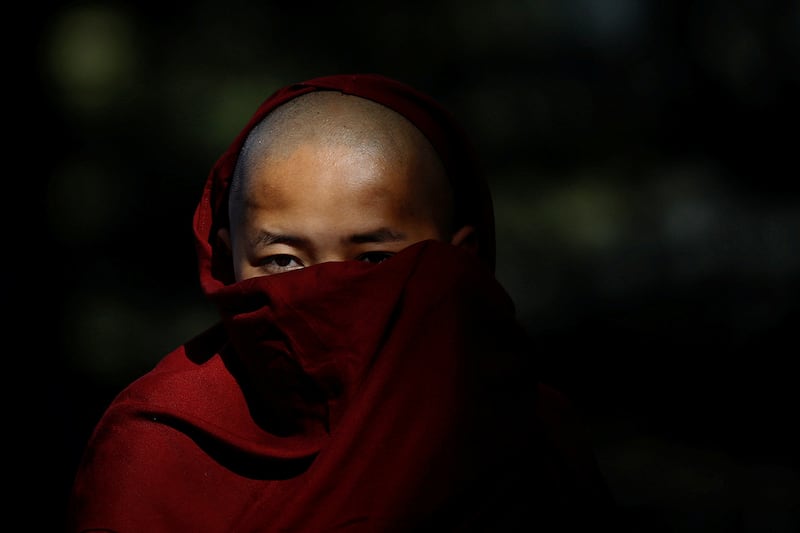 A Tibetan nun listens to a speaker during a protest march held to mark the 65th anniversary of the Tibetan uprising against Chinese rule, in Dharamsala, India, March 10, 2024.