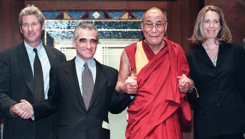In this April 30, 1998, photo, from left to right: Richard Gere, director Martin Scorsese, the Dalai Lama and screenwriter Melissa Mathison hold hands at an awards ceremony honoring Scorsese and Mathison for their work on the film "Kundun."